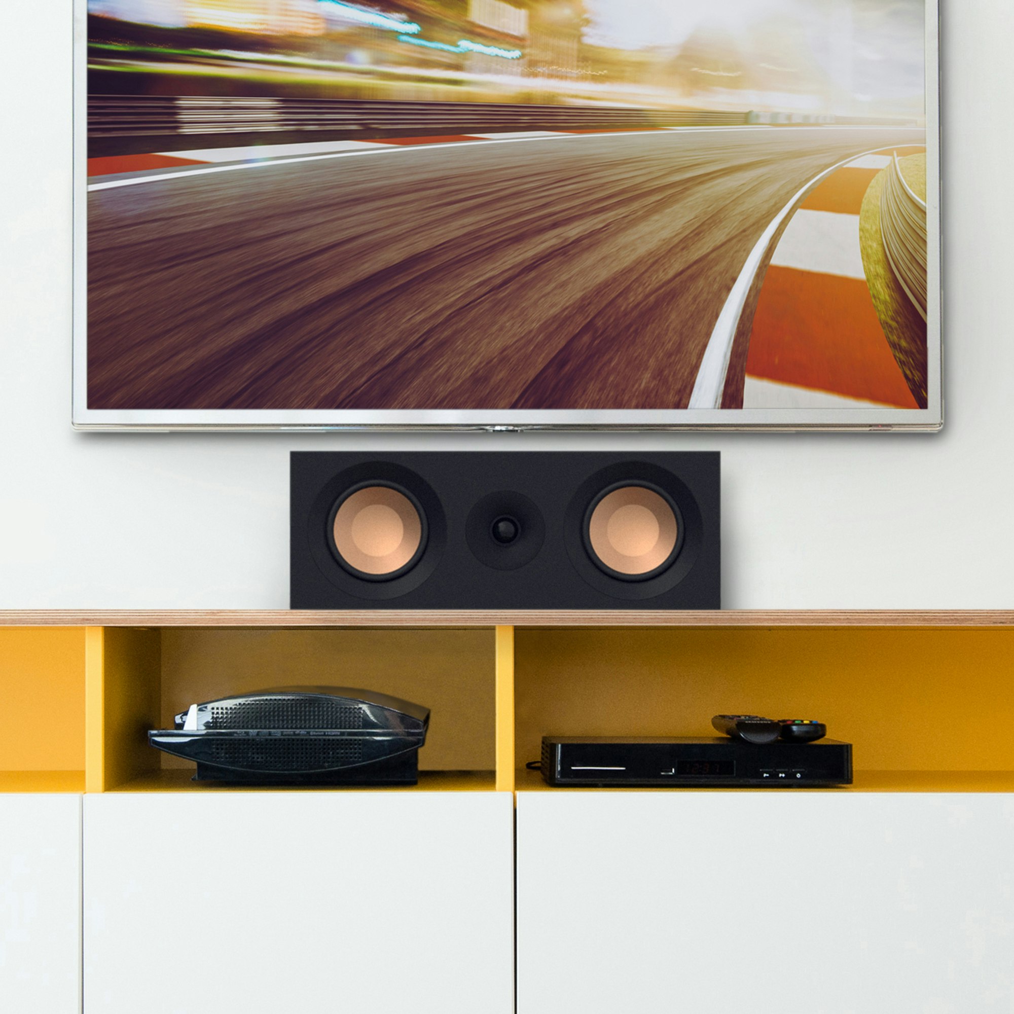KD-52C on a white and yellow credenza under a TV with grille off